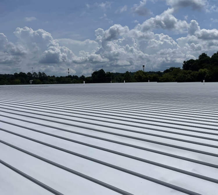 A large white industrial rooftop under a cloudy sky.